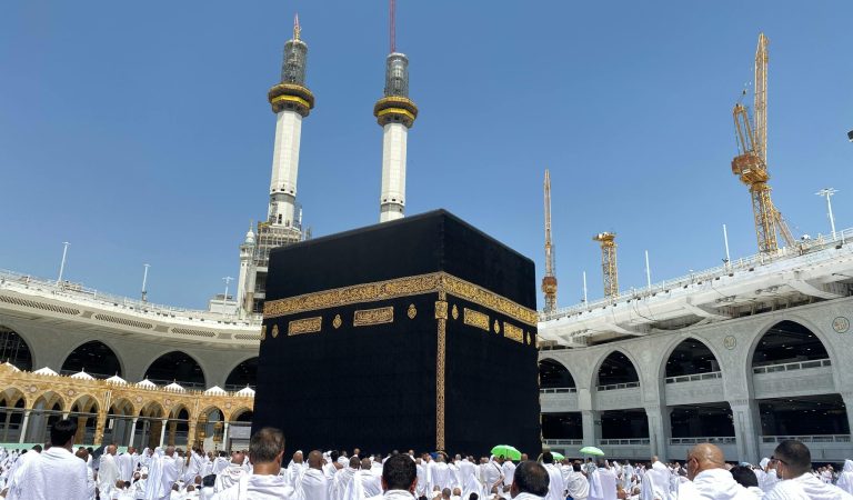 Crowd of worshippers in Mecca surrounding the Kaaba at the Grand Mosque during pilgrimage.